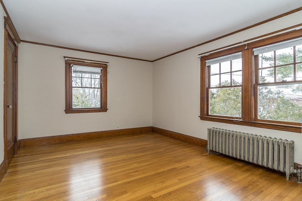 299 Weston Road Wellesley, MA 02482 - Photo 18 of 22 a view of an empty room with wooden floor and a window