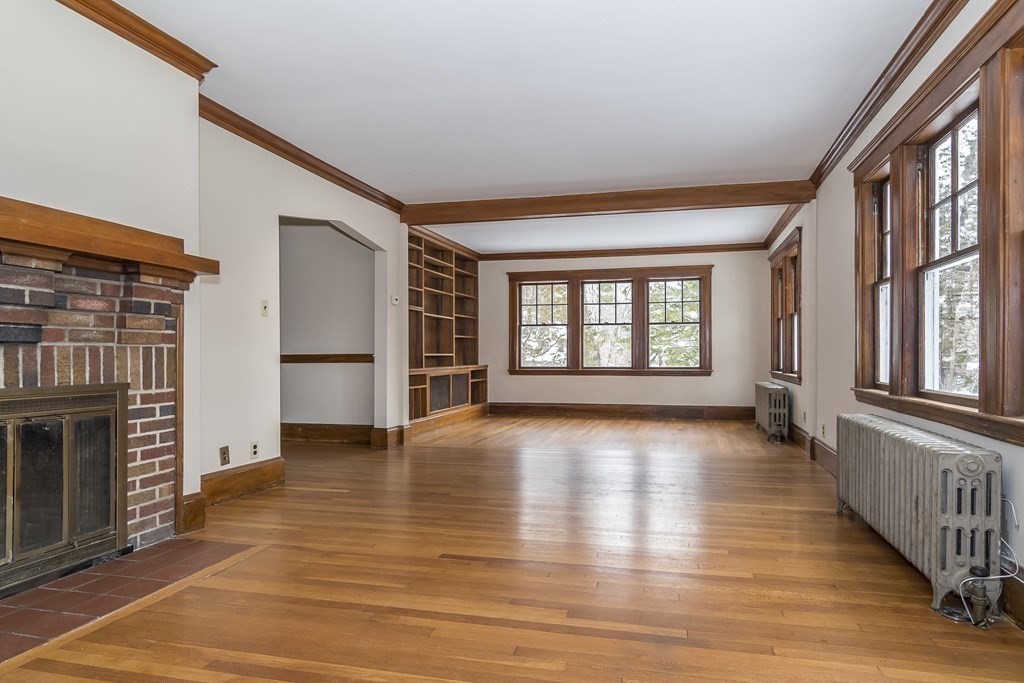 299 Weston Road Wellesley, MA 02482 - Photo 3 of 22 a view of an empty room with wooden floor and a window