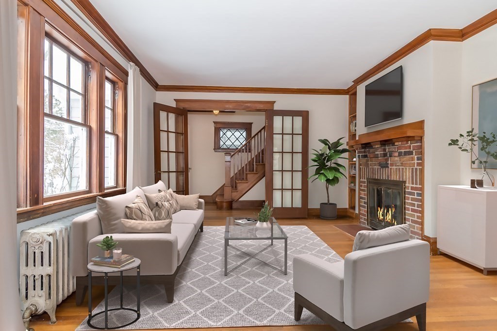 299 Weston Road Wellesley, MA 02482 - Photo 4 of 22 a living room with furniture a fireplace and a large window