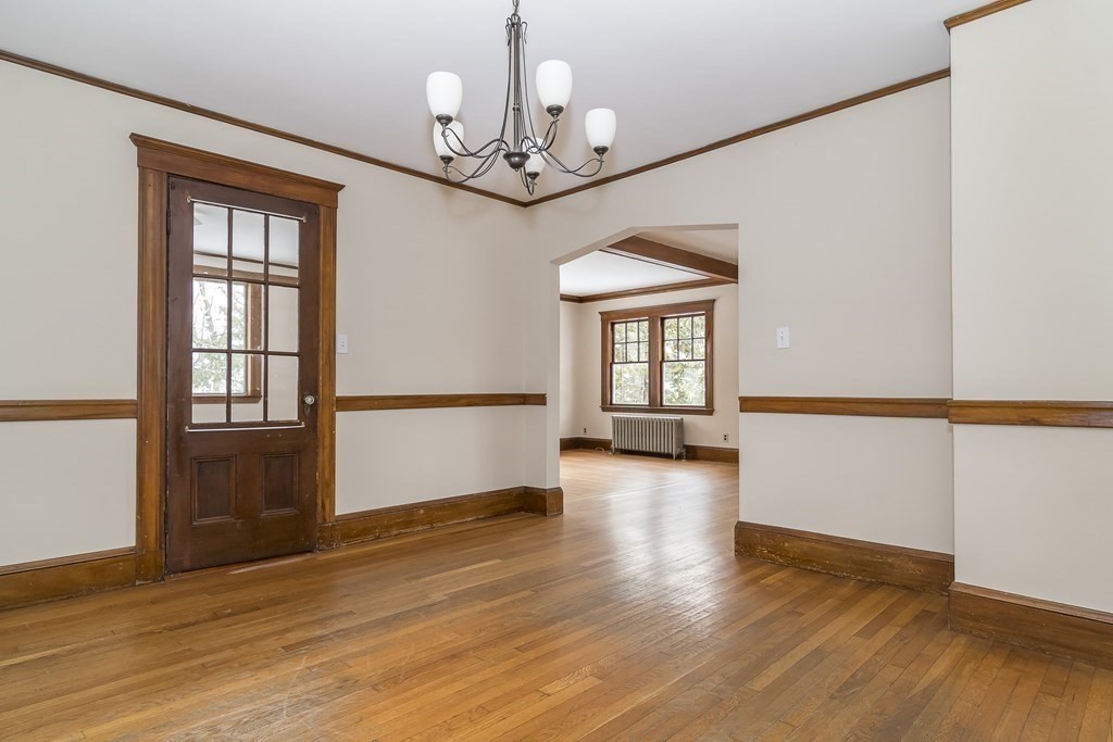 299 Weston Road Wellesley, MA 02482 - Photo 7 of 22 a view of a livingroom with wooden floor and chandelier