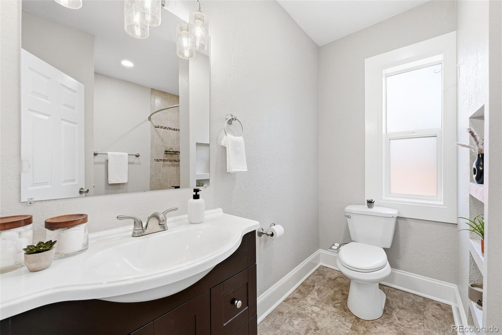 3324 Franklin Street Denver, CO 80205 - Photo 19 of 50 a bathroom with a sink toilet and a mirror