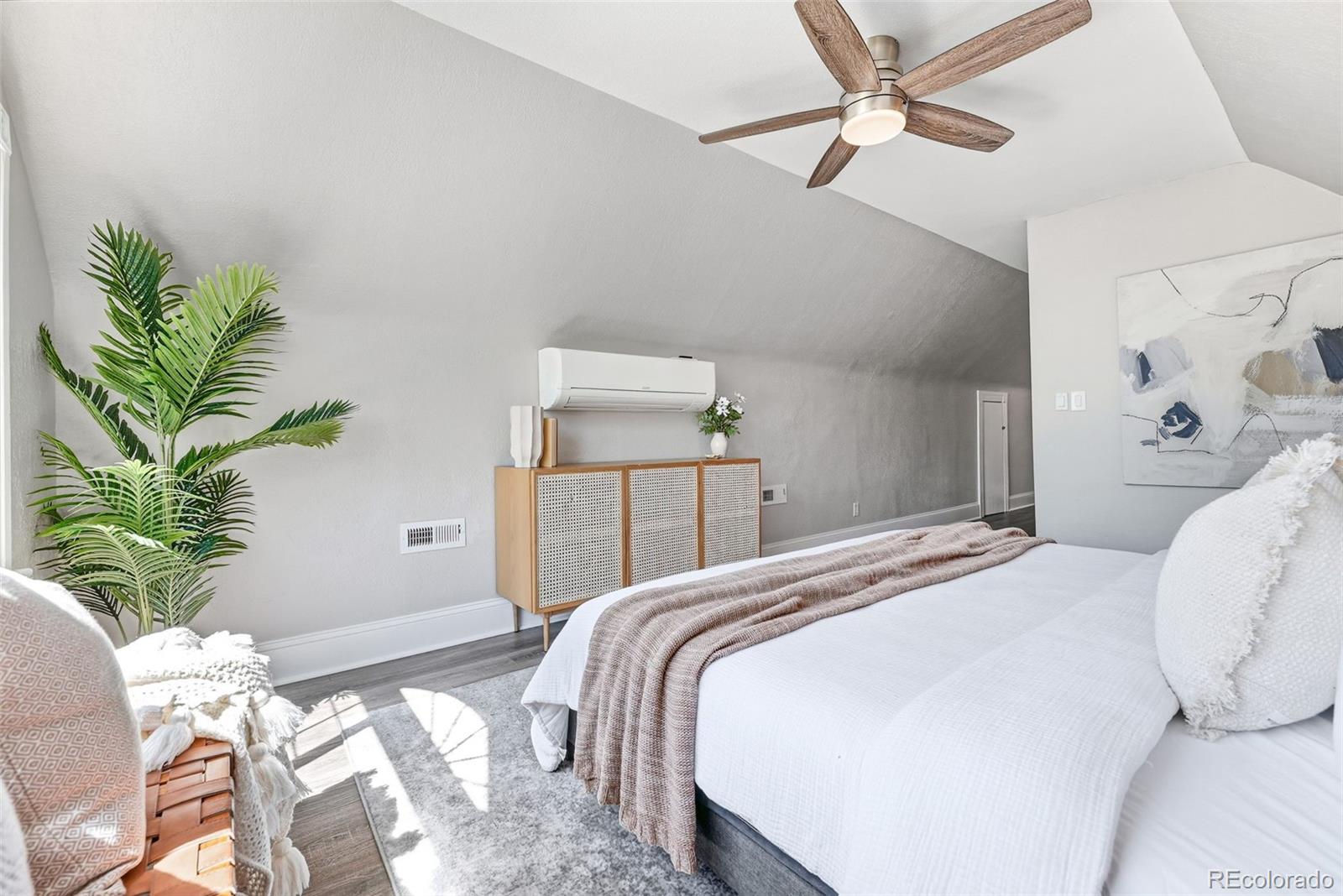 3324 Franklin Street Denver, CO 80205 - Photo 24 of 50 a bedroom with a bed and a potted plant