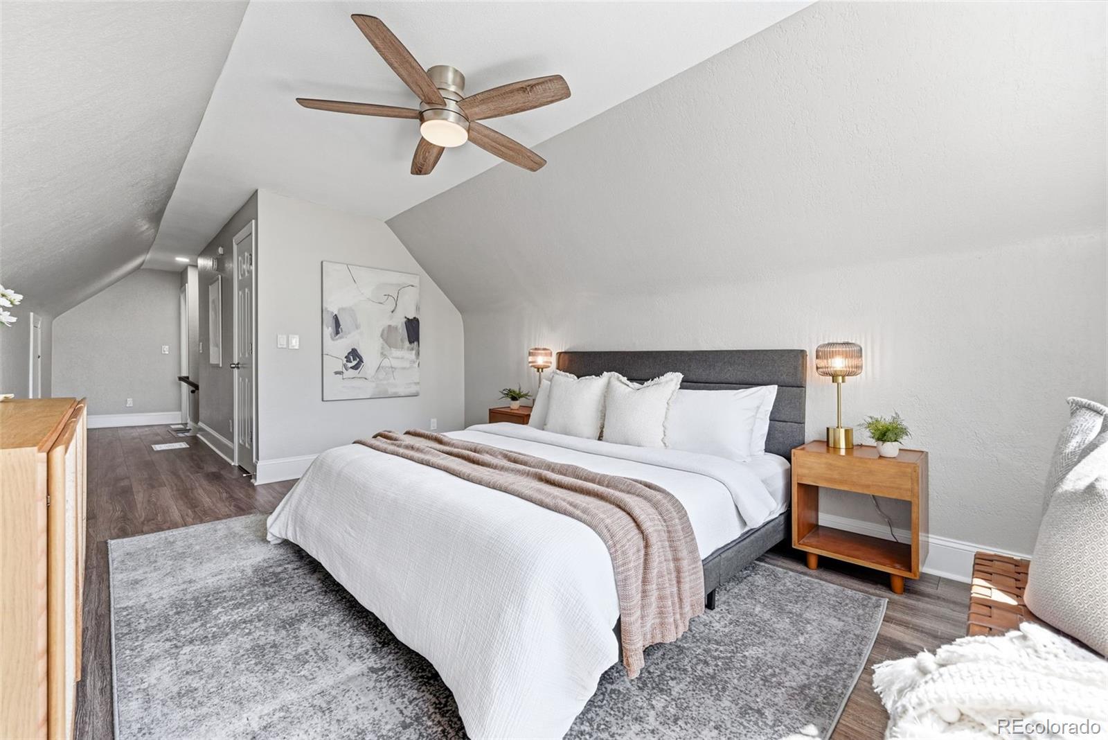 3324 Franklin Street Denver, CO 80205 - Photo 25 of 50 a bedroom with a bed and a ceiling fan