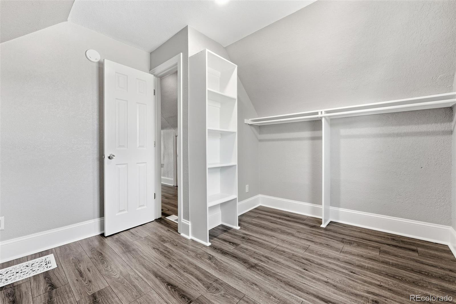 3324 Franklin Street Denver, CO 80205 - Photo 28 of 50 a view of an empty room with wooden floor and a window