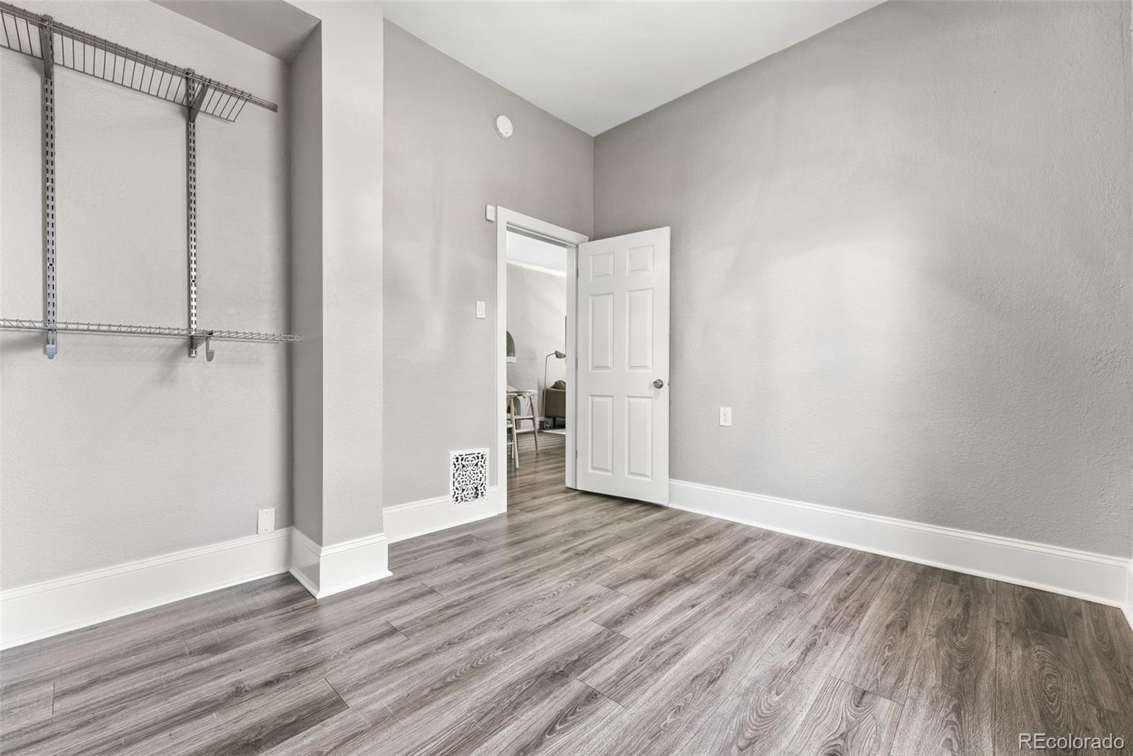 3324 Franklin Street Denver, CO 80205 - Photo 35 of 50 a view of an empty room with wooden floor
