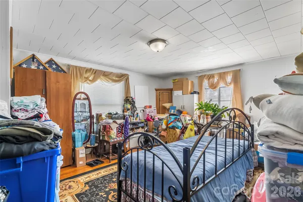 a bedroom with furniture a fireplace and a flat tv screen