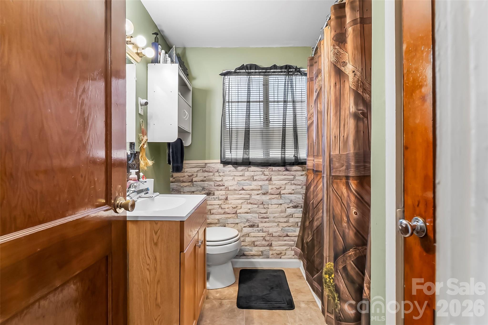 2706 Connelly Springs Road Granite Falls, NC 28630 - Photo 17 of 34 a bathroom with a sink a toilet and shower