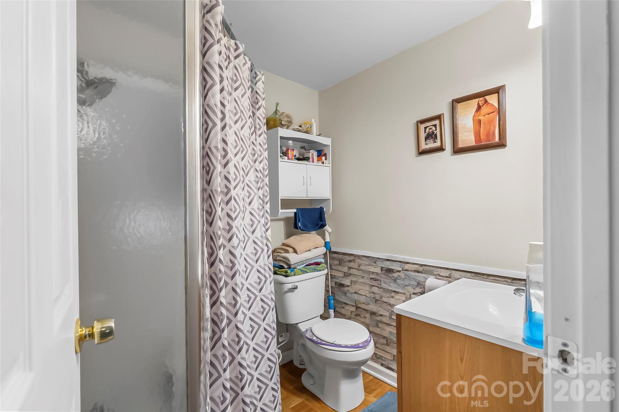 2706 Connelly Springs Road Granite Falls, NC 28630 - Photo 19 of 34 a bathroom with a toilet and a shower curtain