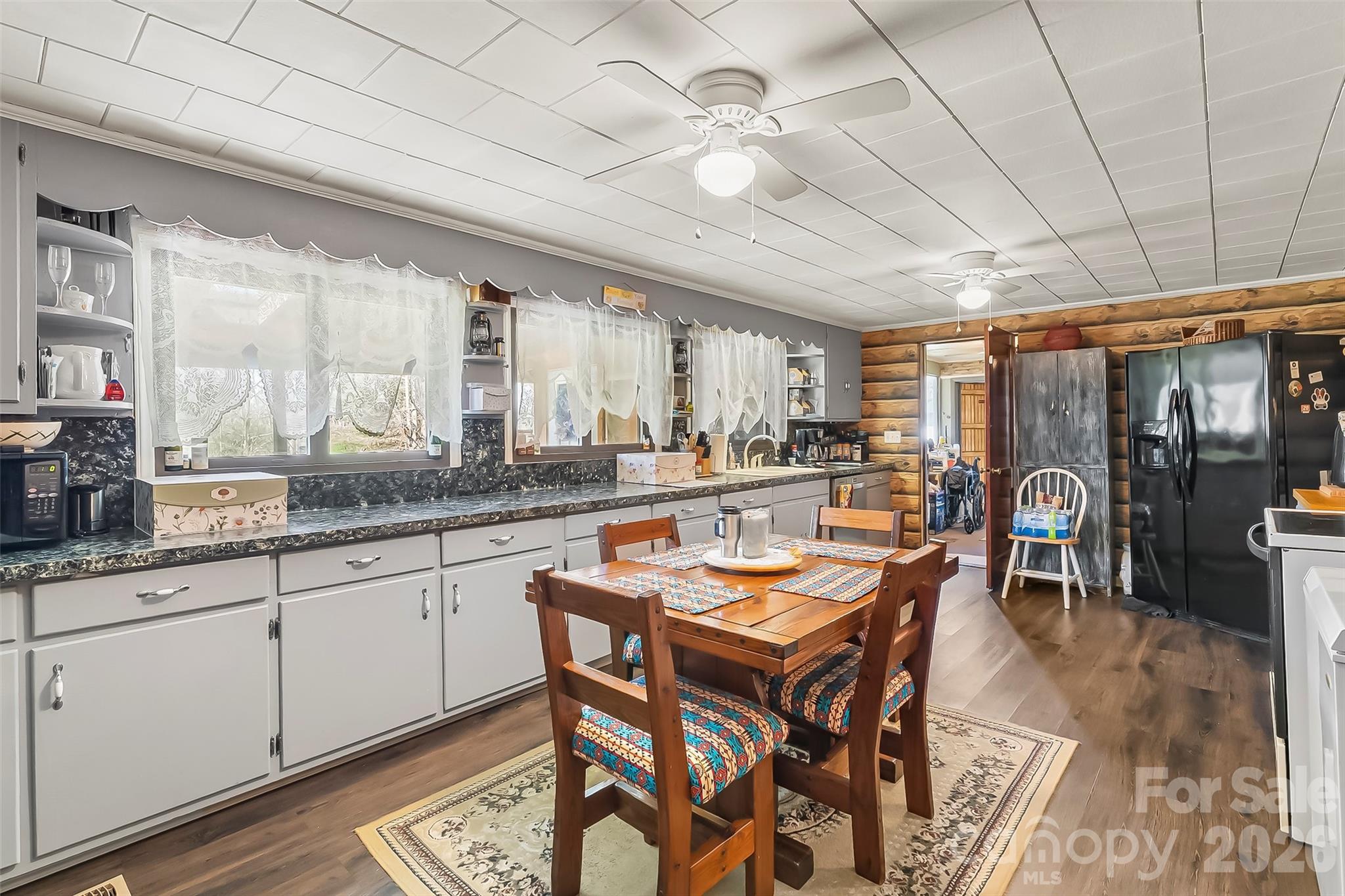 2706 Connelly Springs Road Granite Falls, NC 28630 - Photo 7 of 34 a dining hall with stainless steel appliances granite countertop a stove a sink a dining table and chairs