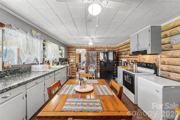 a kitchen with a sink appliances and cabinets