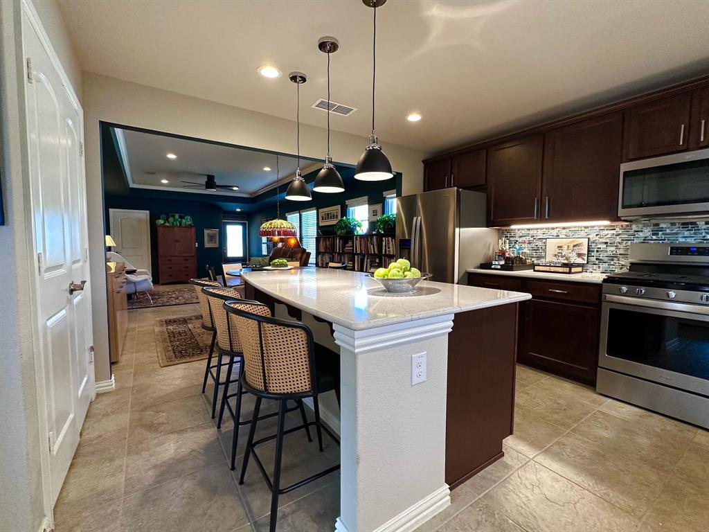 1884 Marsh Point Drive Frisco, TX 75036 - Photo 12 of 23 a kitchen with a sink appliances and cabinets