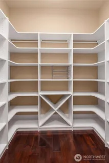 a view of walk in closet with empty racks