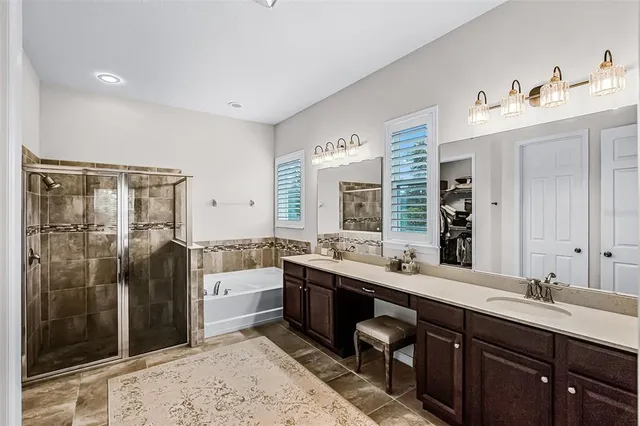 a large bathroom with double vanity and a mirror