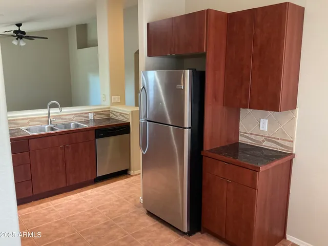 a kitchen with stainless steel appliances granite countertop a refrigerator and a sink