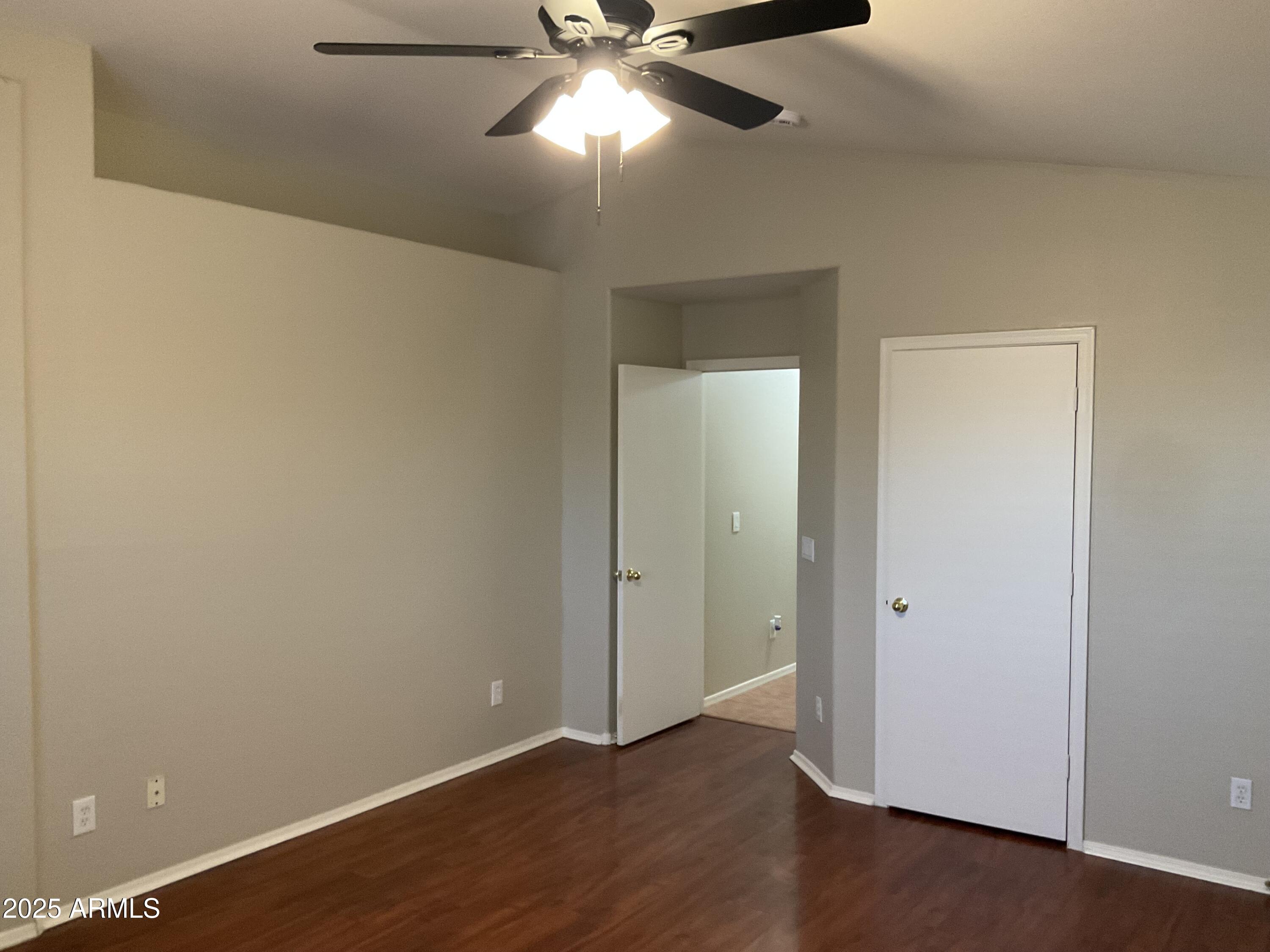 1896 South Pinto Drive Apache Junction, AZ 85120 - Photo 5 of 13 an empty room with wooden floor closet and windows