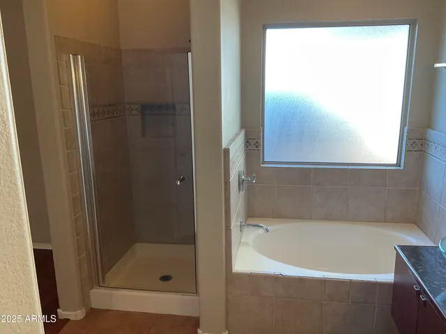 a bathroom with a bathtub and a shower