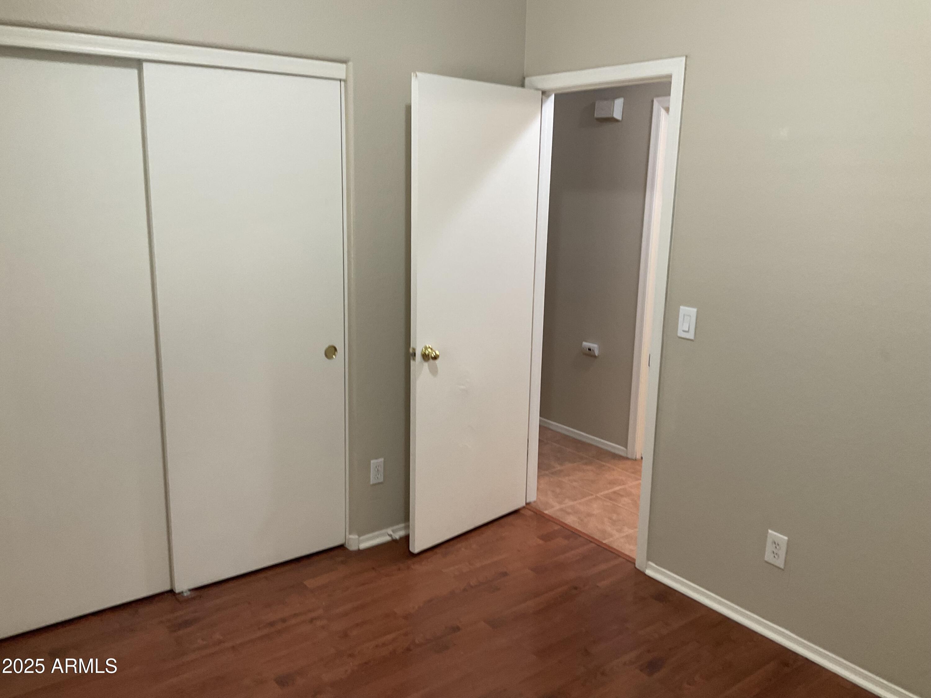 1896 South Pinto Drive Apache Junction, AZ 85120 - Photo 9 of 13 a view of an empty room with wooden floor