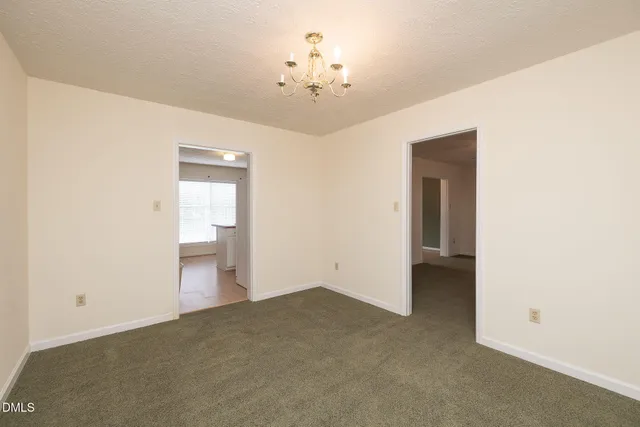 a view of a chandelier fan and entryway