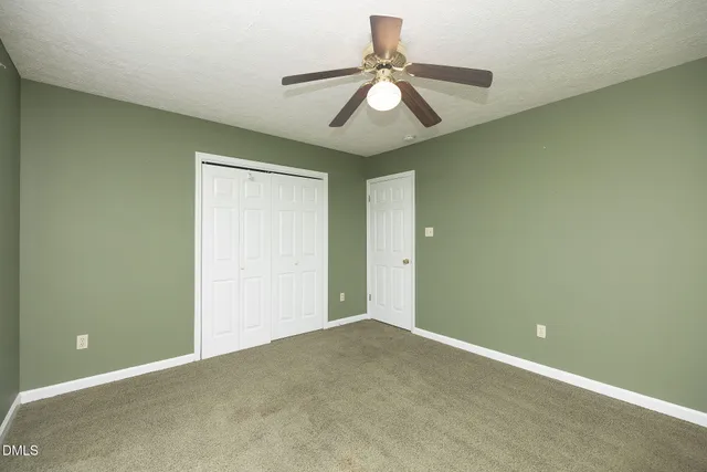 a view of a room with a ceiling fan