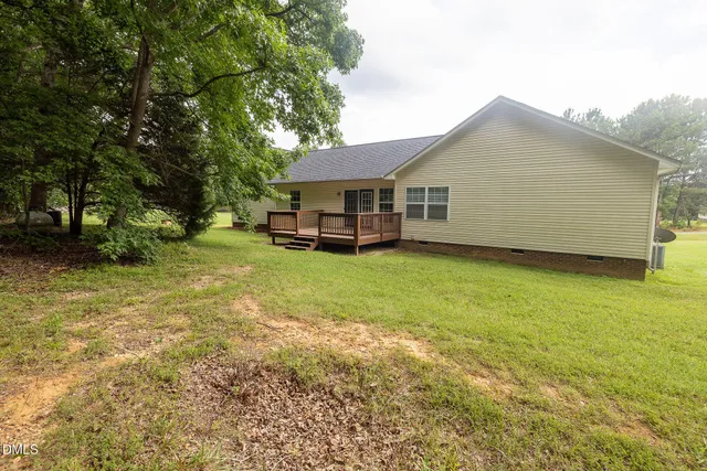 a view of a house with a yard and sitting area