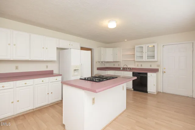 a kitchen with white cabinets and white appliances