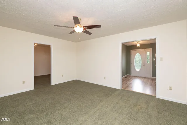 an empty room with closet and windows