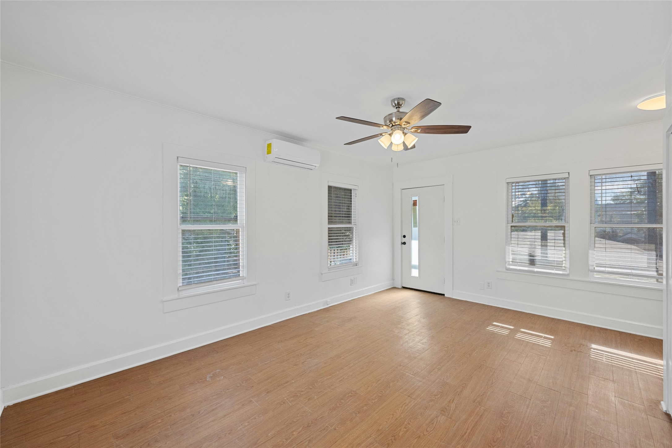 2201 Leon Street, Unit G Austin, TX 78705 - Photo 3 of 17 Bright interior space featuring wood-finish flooring and multiple windows