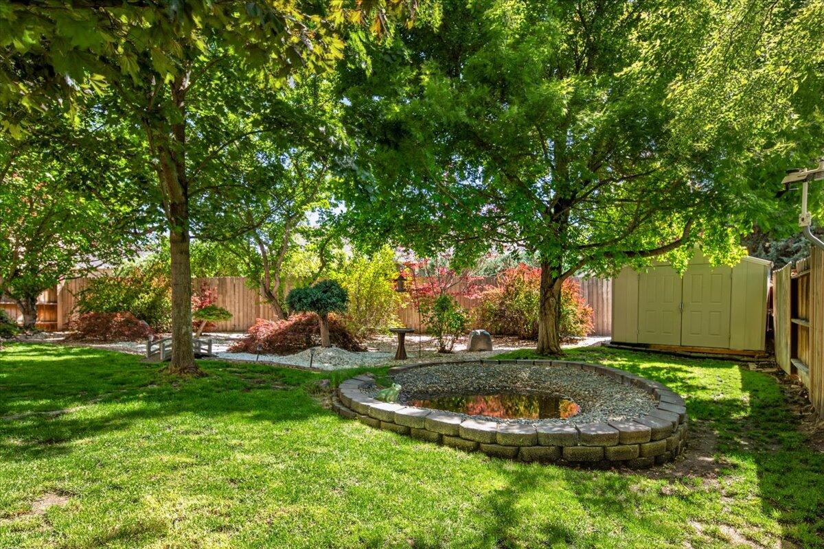 1339 Southwest Rimrock Way Redmond, OR 97756 - Photo 23 of 26 a view of a backyard with large trees