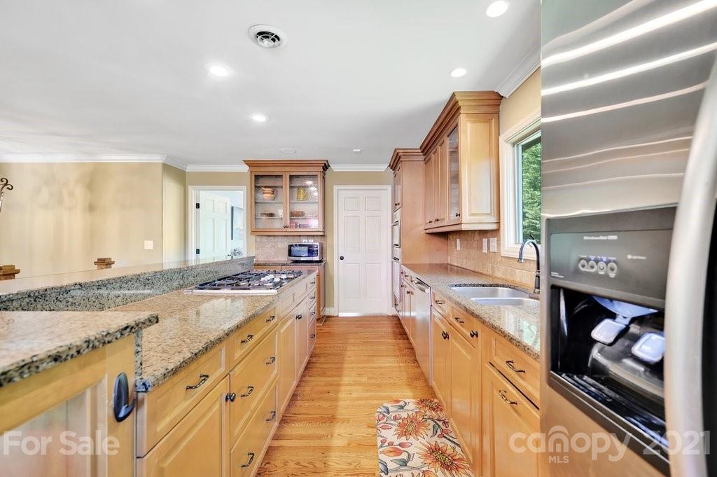 16123 Tana Tea Circle Tega Cay, SC 29708 - Photo 23 of 42 a large kitchen with stainless steel appliances granite countertop a large counter top and a stove