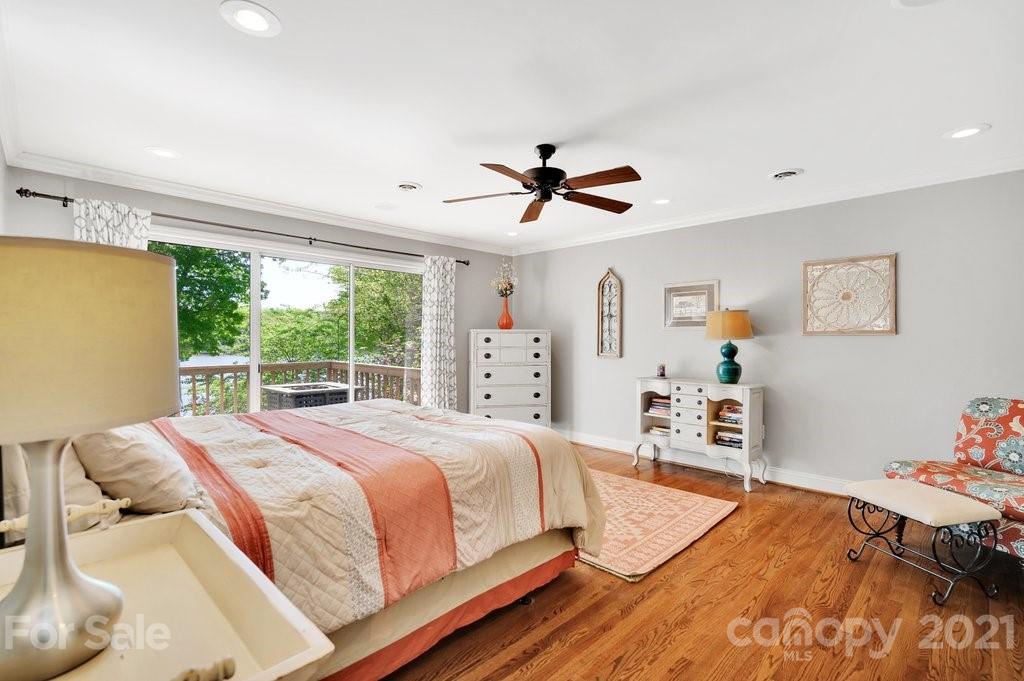 16123 Tana Tea Circle Tega Cay, SC 29708 - Photo 26 of 42 a bedroom with a bed and a chandelier