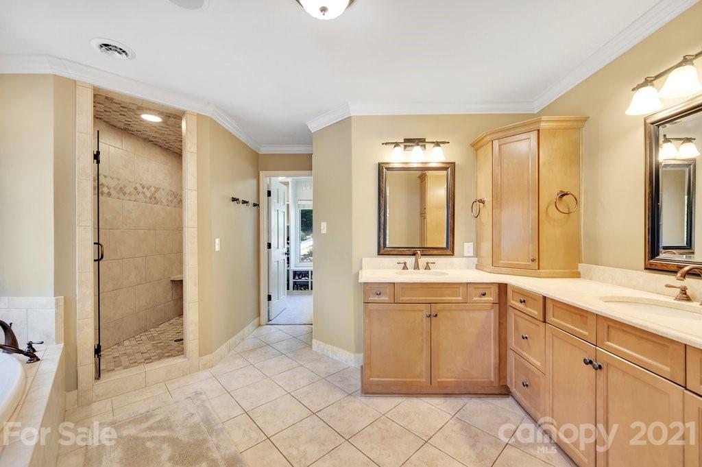 16123 Tana Tea Circle Tega Cay, SC 29708 - Photo 29 of 42 a spacious bathroom with a shower sink and mirror
