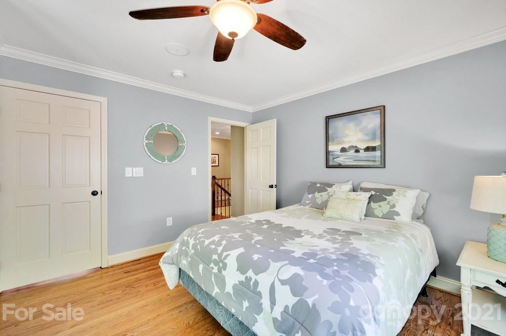 16123 Tana Tea Circle Tega Cay, SC 29708 - Photo 34 of 42 a bedroom with a bed and a painting on the wall