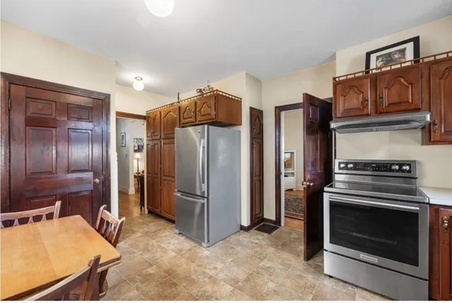 a kitchen with stainless steel appliances granite countertop a refrigerator and a stove