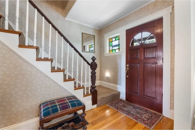 a view of an entryway with wooden floor