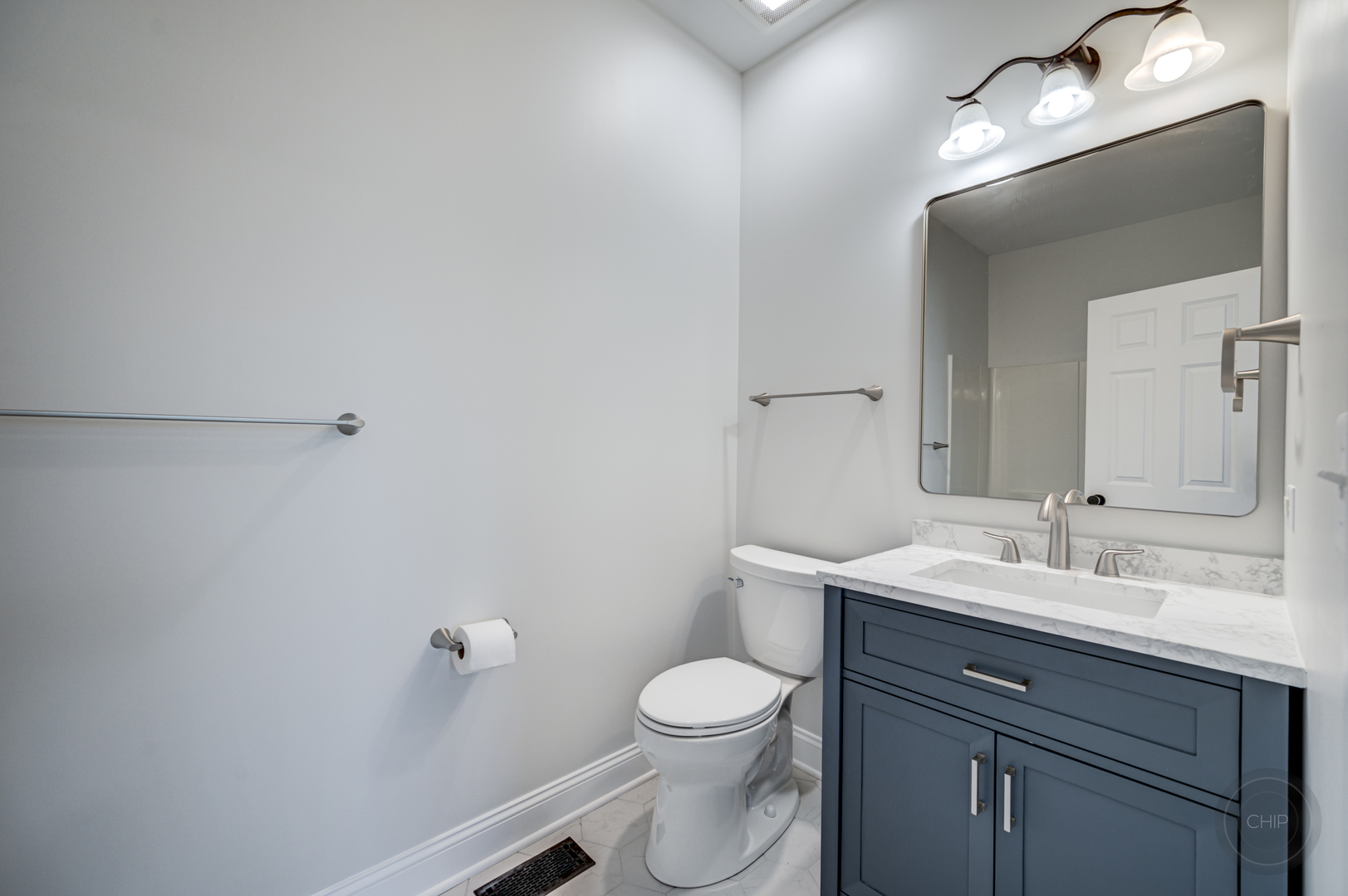 12948 Parterre Place Plainfield, IL 60585 - Photo 20 of 35 a bathroom with a toilet a sink a light fixture and mirror