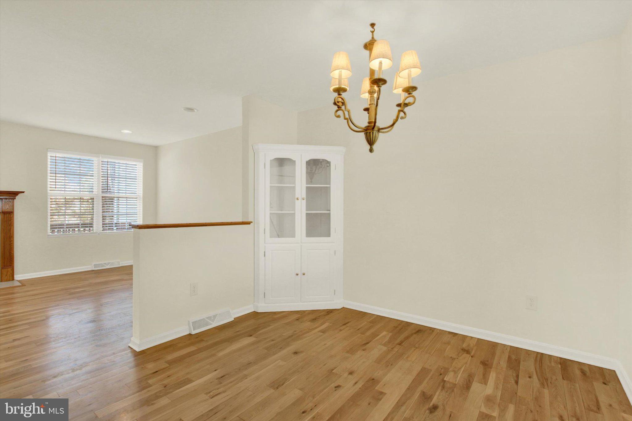 170 Morningstar Court Hanover, PA 17331 - Photo 11 of 32 an empty room with wooden floor and windows