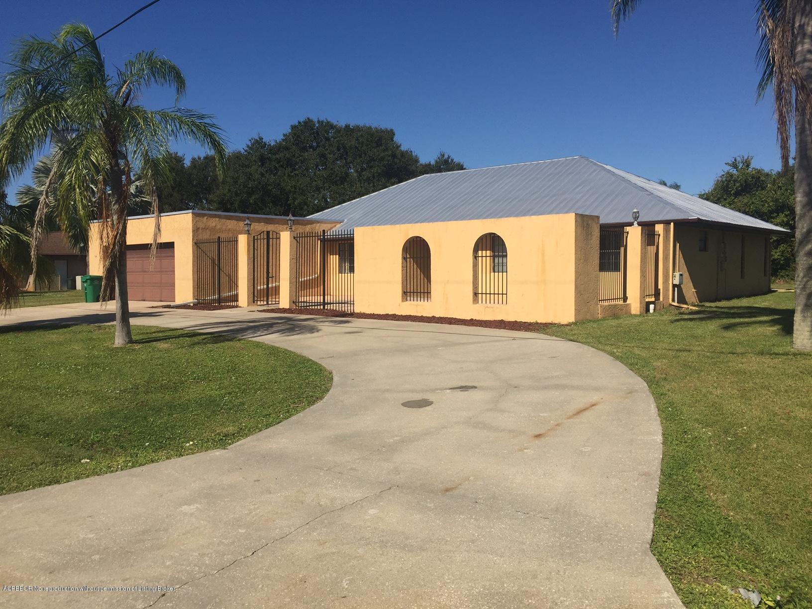 2812 Southeast Farley Road Port St. Lucie, FL 34952 - Photo 1 of 3 a front view of a house with a yard and garage