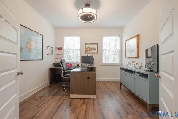 a kitchen with a refrigerator a sink dishwasher a stove and white cabinets with wooden floor