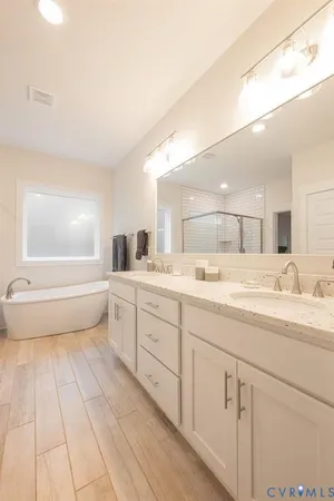 a large kitchen with lots of counter space a sink and chairs