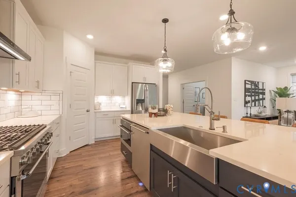 a kitchen with sink stove and cabinets