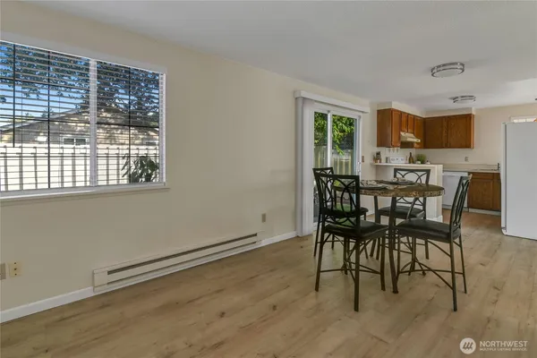a view of a dining room with furniture and window