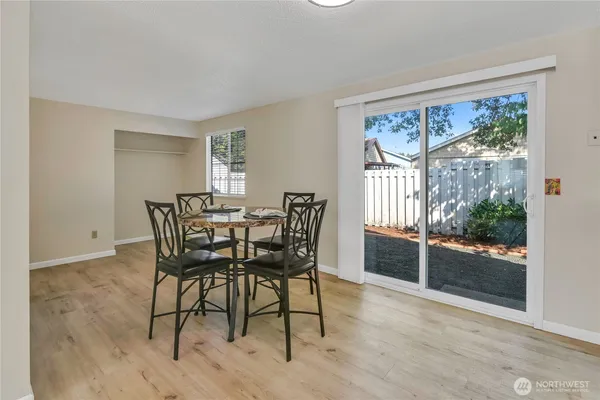 a view of a dining room with furniture large windows and wooden floor