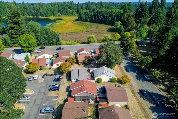 an aerial view of residential houses with outdoor space and swimming pool