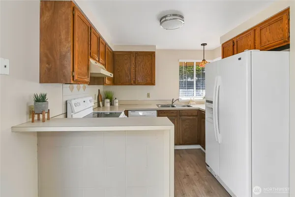 a kitchen with a sink a refrigerator and a stove