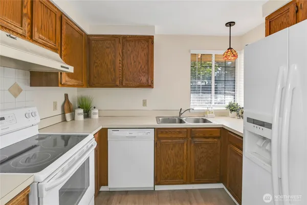 a kitchen with a sink stove and cabinets