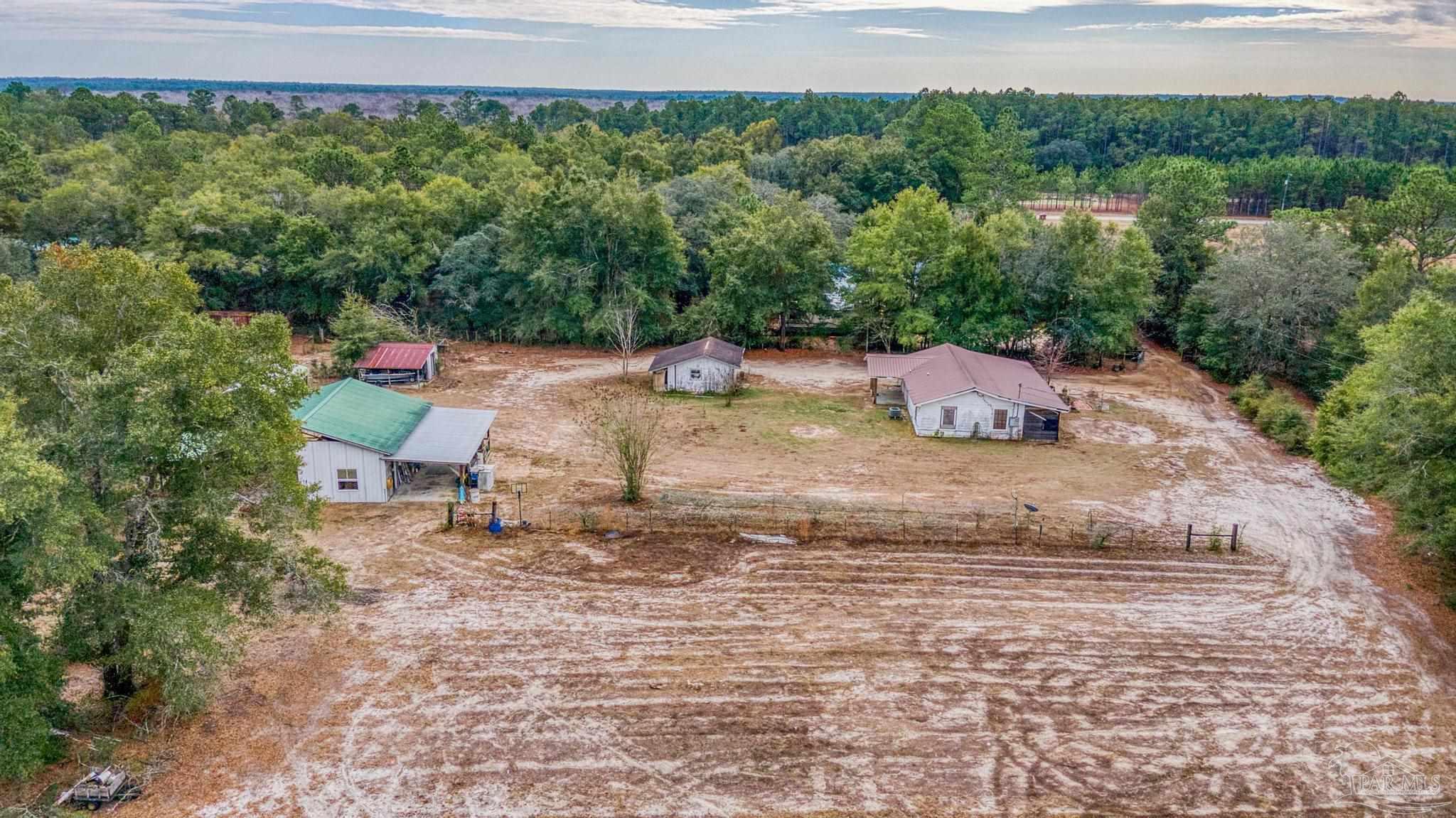 10246 Nichols Lake Road Milton, FL 32583 - Photo 13 of 43 a backyard of a house with a yard and outdoor seating