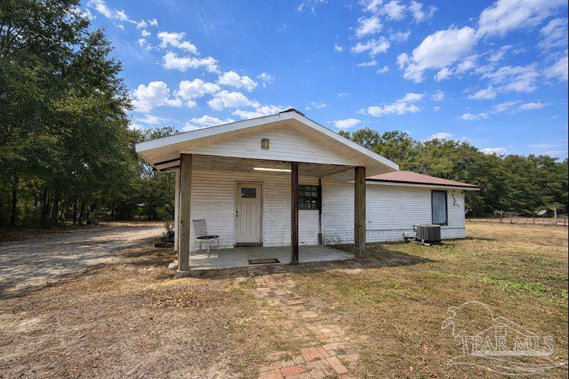 10246 Nichols Lake Road Milton, FL 32583 - Photo 16 of 43 a front view of a house with garden