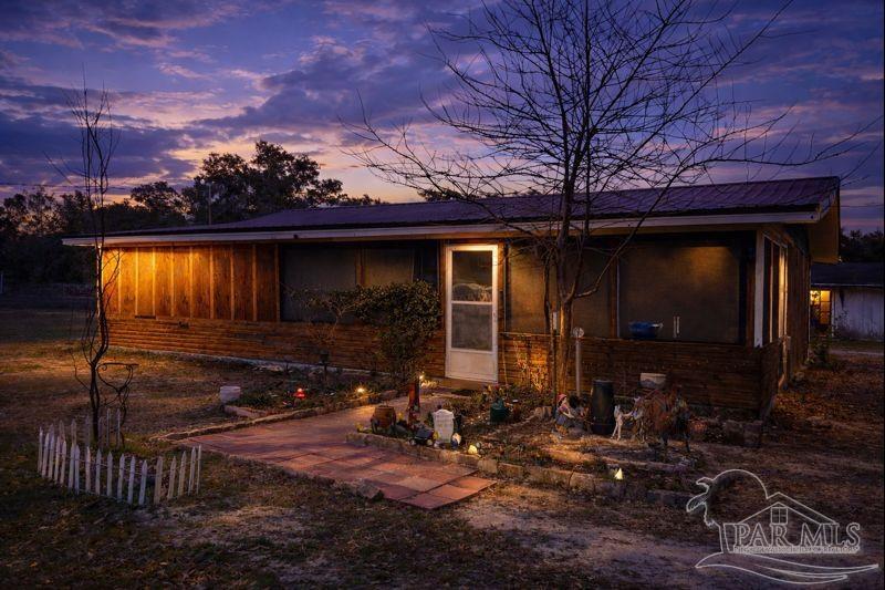 10246 Nichols Lake Road Milton, FL 32583 - Photo 17 of 43 a view of house with backyard space and patio