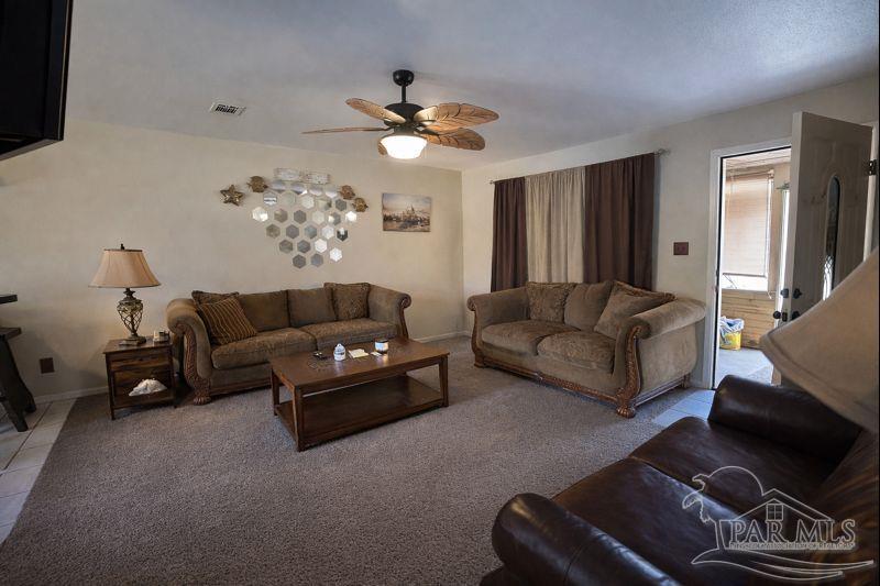 10246 Nichols Lake Road Milton, FL 32583 - Photo 21 of 43 a living room with furniture and a flat screen tv