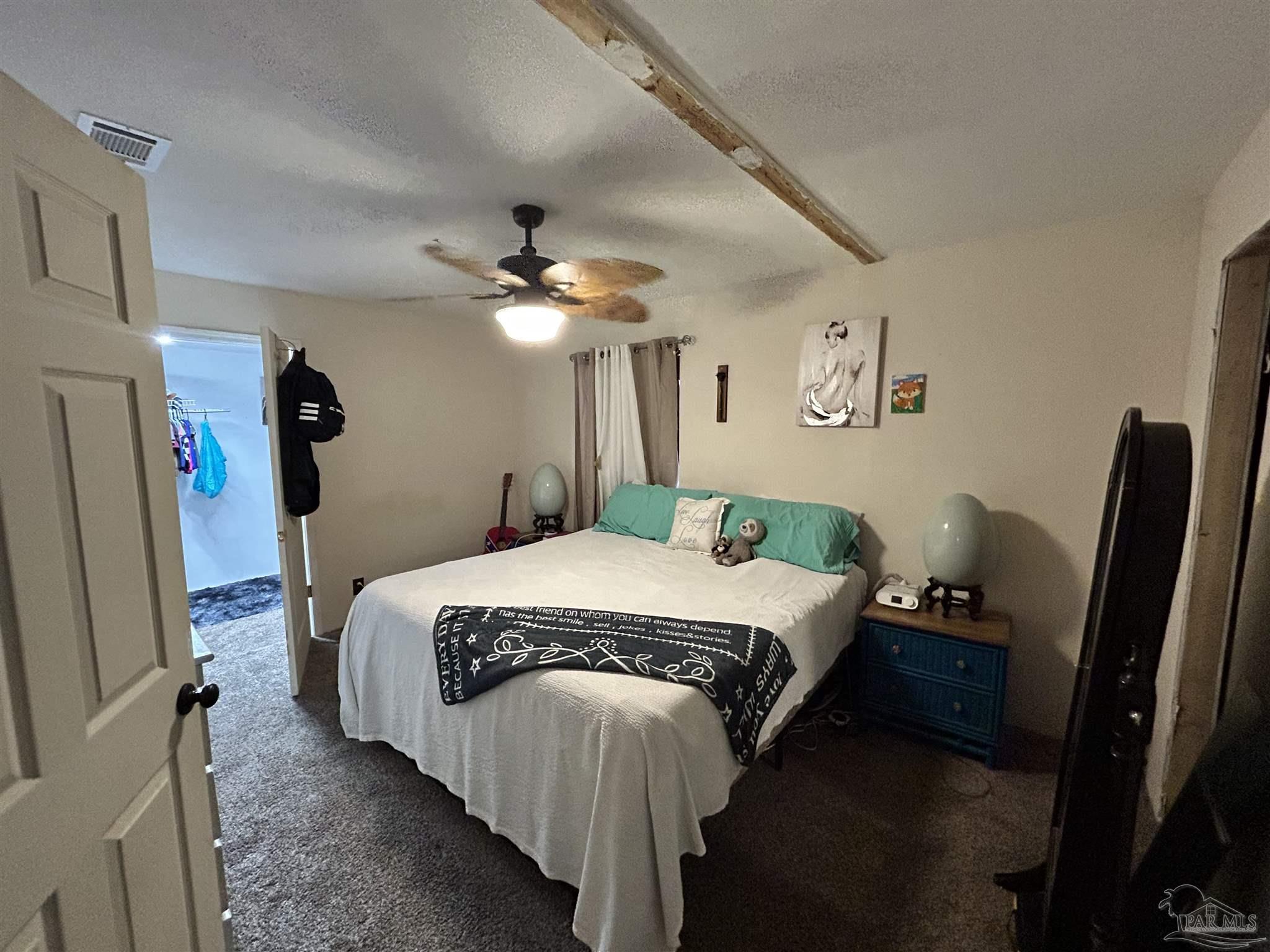 10246 Nichols Lake Road Milton, FL 32583 - Photo 24 of 43 a bedroom with a bed and a mirror